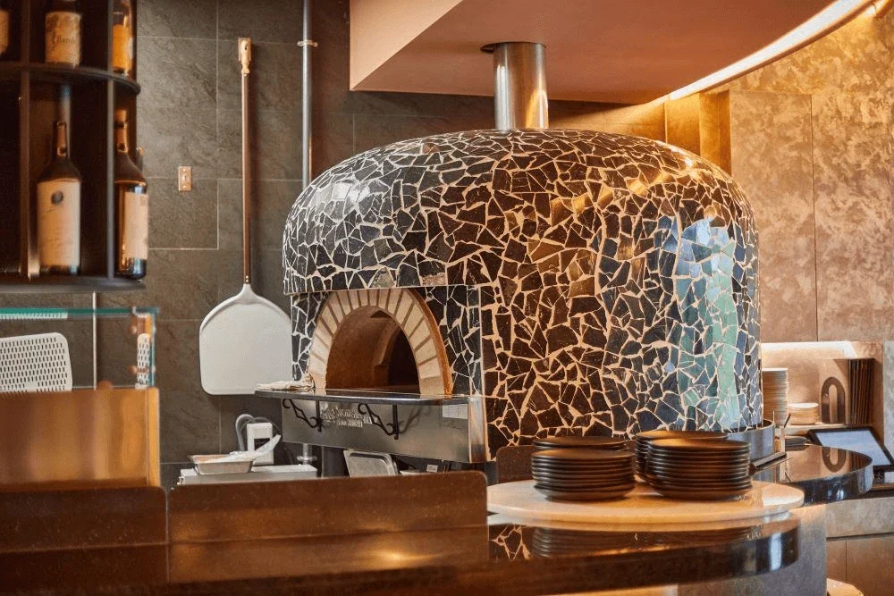 Mosaic-tiled professional pizza oven in commercial kitchen, Canada