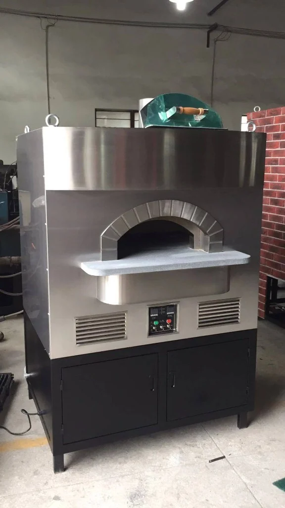 Freestanding stainless steel dome outdoor pizza oven with arched mouth, stone landing, dual digital controls, side vents, and black storage cabinet base