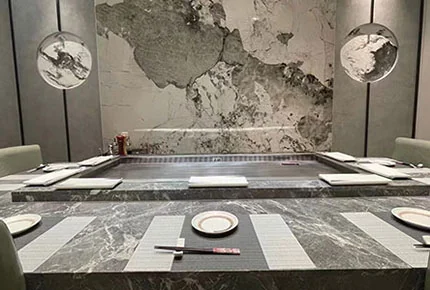 Marble teppanyaki counter with place settings in a private dining room