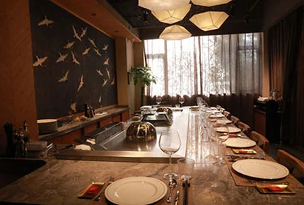 Stainless-steel teppanyaki grill line in a restaurant kitchen