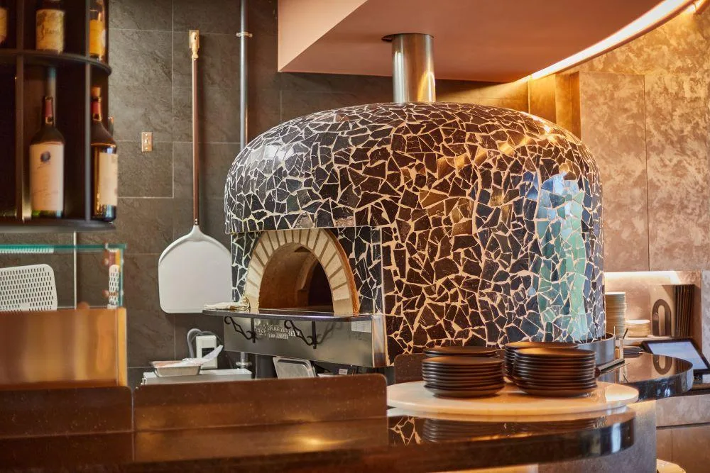 Close-up of a commercial pizza oven volcanic stone baking deck showing thick stone slabs and heat-resistant interior