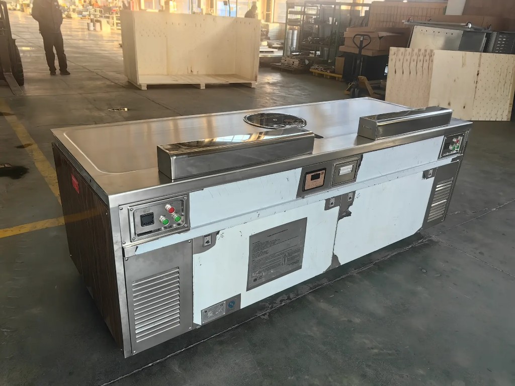 Stainless steel commercial teppanyaki line with flat top, modules, and digital controls in factory