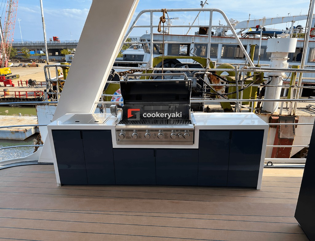 Cookeryaki outdoor kitchen island with stainless grill on a wooden yacht deck