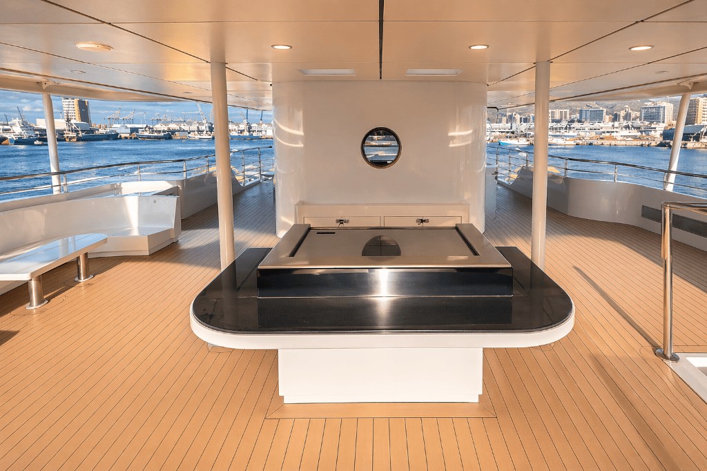 Built-in teppanyaki flat top on a luxury yacht deck with harbor view