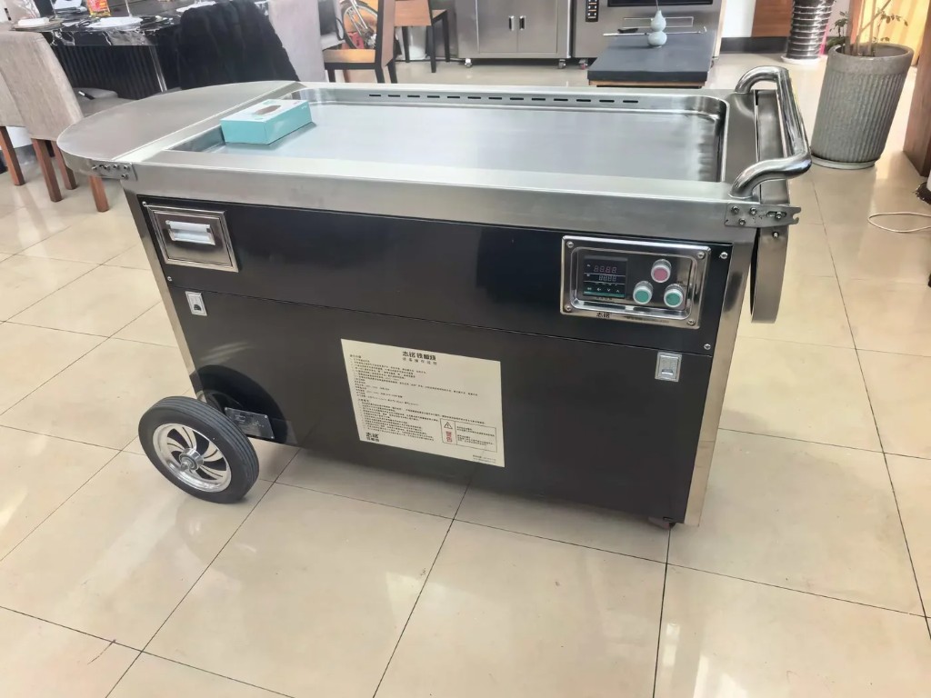 Black cabinet portable teppanyaki with digital control panel.