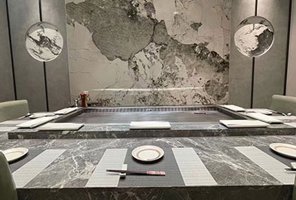Marble teppanyaki counter with place settings in a private dining room