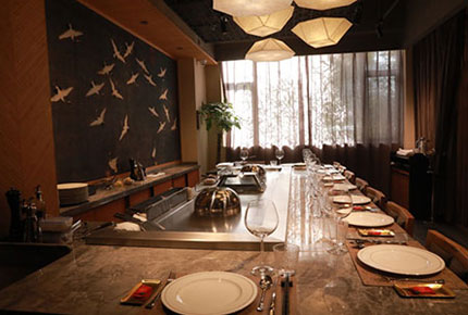 Stainless-steel teppanyaki grill line in a restaurant kitchen