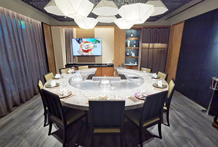 Private dining room with round marble teppanyaki table and seating