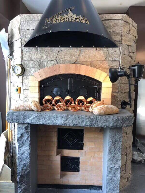 Custom wood fired and gas powered pizza oven with lava stone deck for home patio and commercial kitchen projects